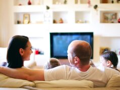 From Keywords to Conversations: How to Optimize Your Guesthouse for AI Assistants Family relaxin a hotel room with streaming enetertainment